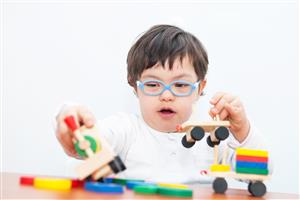 Boy with special needs playing with toys 